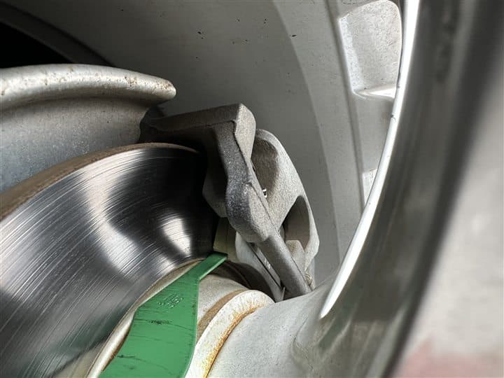 Brake pad thickness being measured