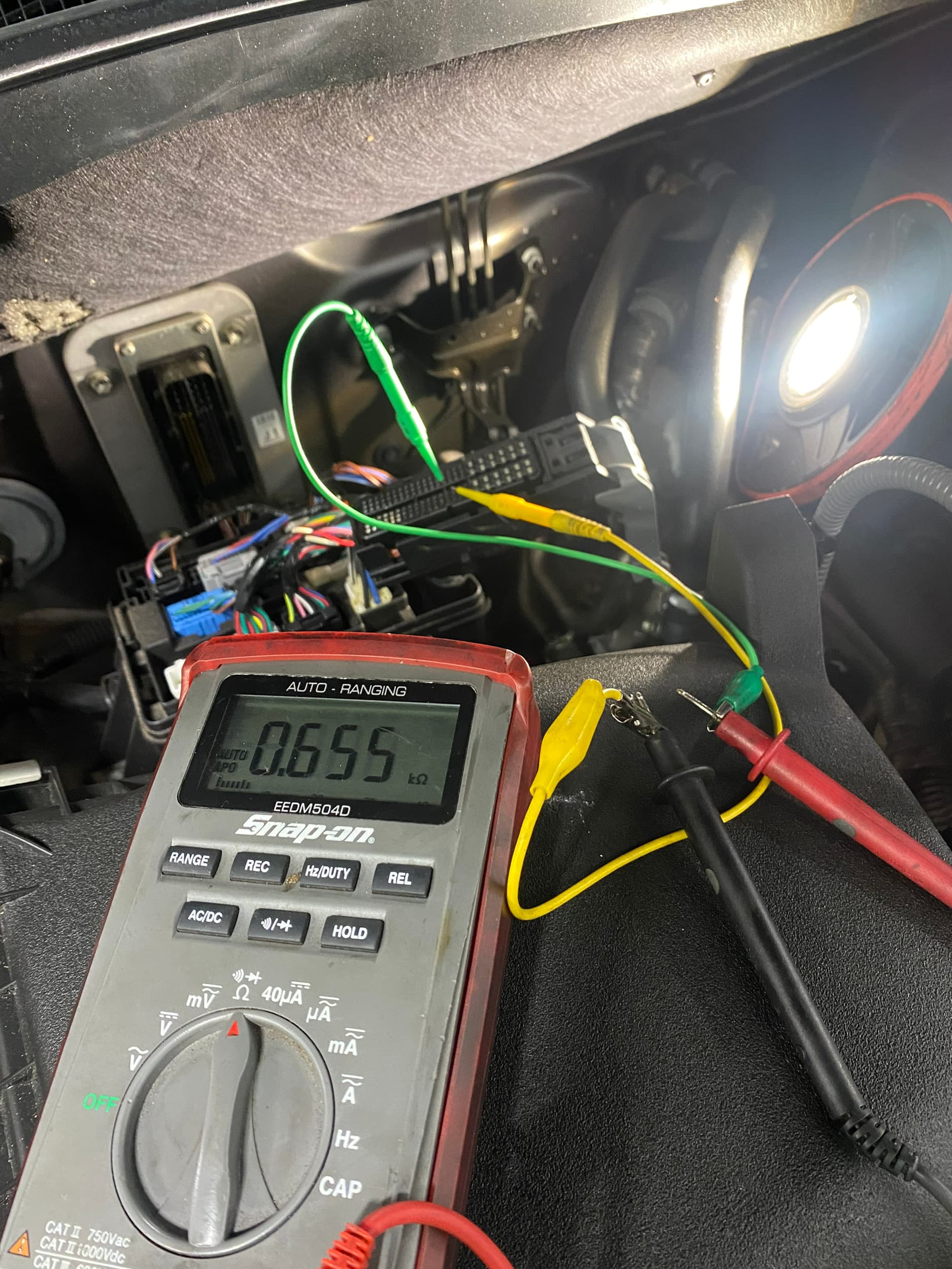 Electrical resistance testing inside a vehicle dashboard