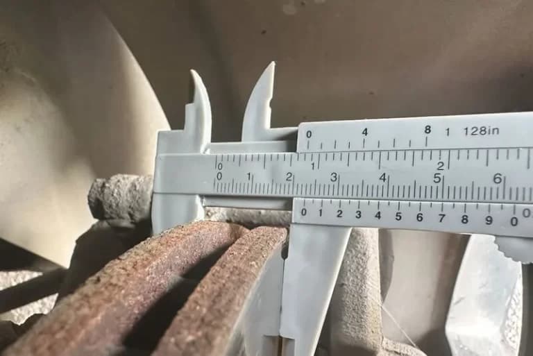 Brake rotor thickness being measured with a caliper