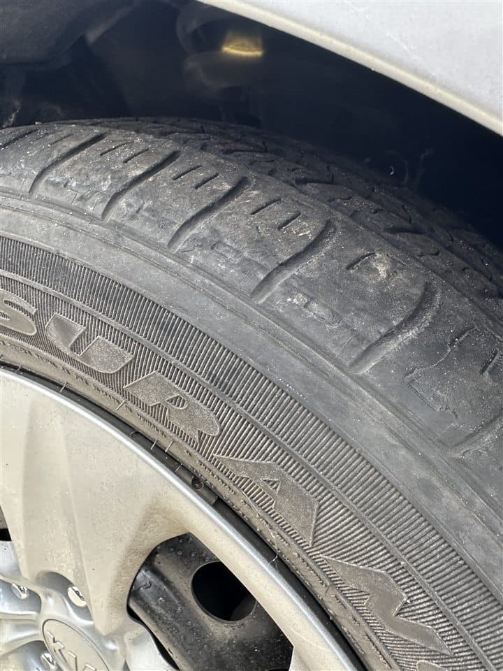 Close-up inspection of uneven tire wear
